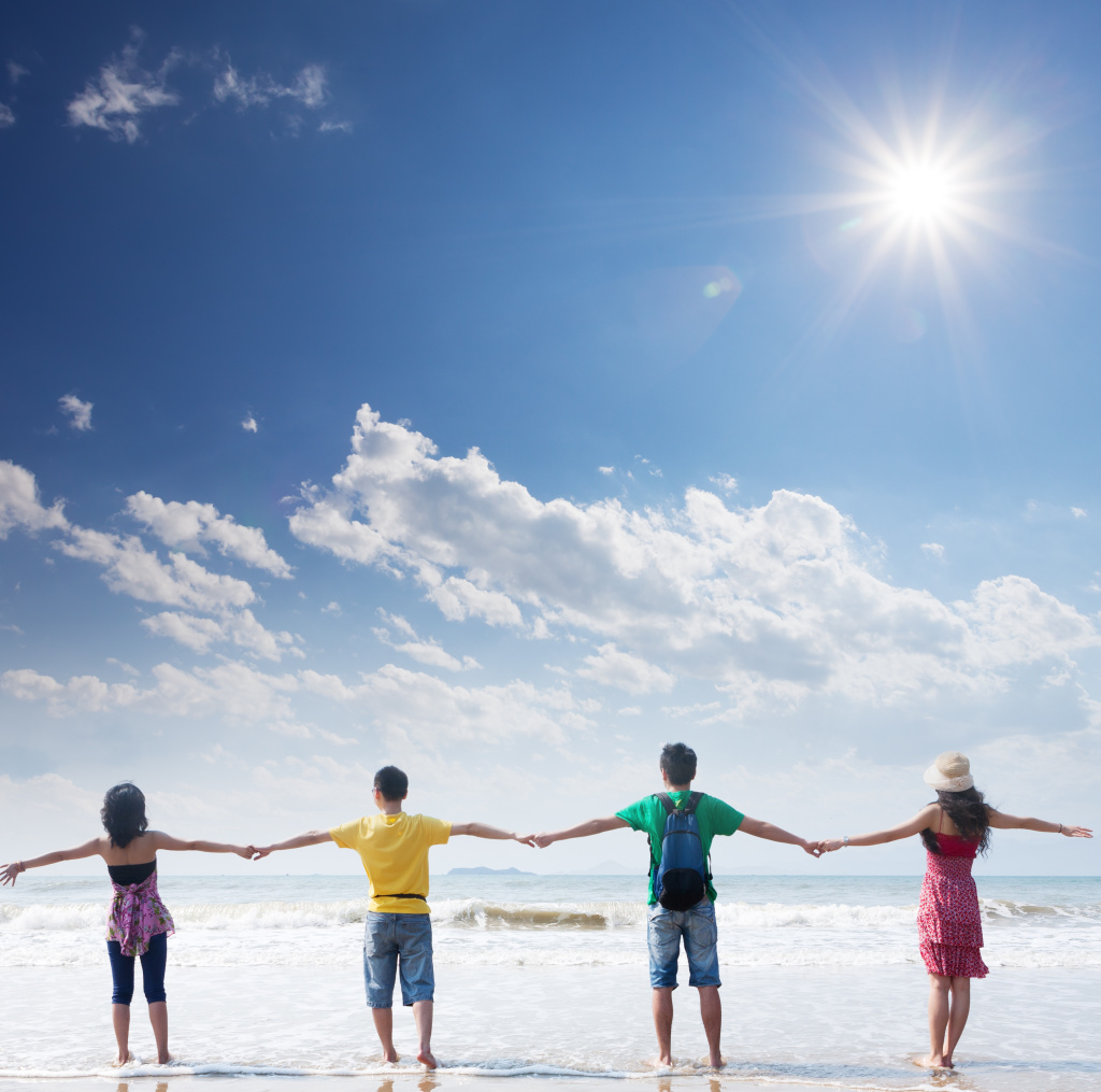 friends holding togehter on beach